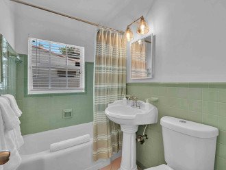 A conveniently-located full bathroom can be found in the open common area as well.