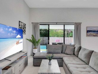 The living space features a comfortable lounge area and smart TV.