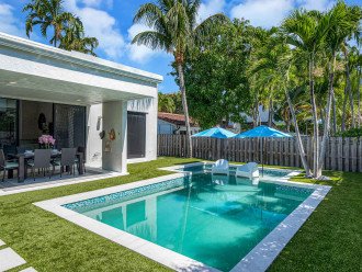 The private garden features a heated pool with loungers, tanning shelf and al fresco dining.