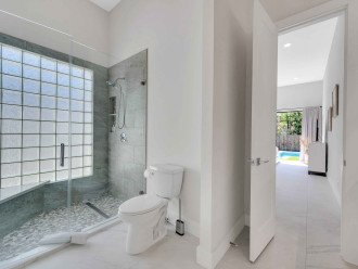 The en-suite primary bathroom features two sinks an a walk-in shower.