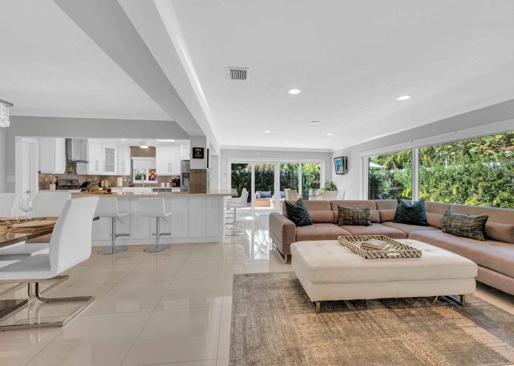 This modern coastal ranch style residence is ideal for tranquil relaxation and privacy with its lush garden and heated pool.