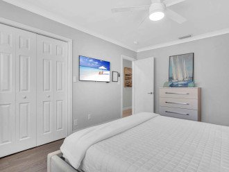 Bedroom four holds a queen bed, closet space, smart TV and ensuite bathroom.
