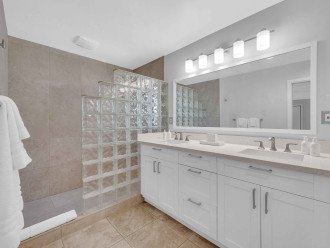 The primary bathroom features a walk-in shower and double sinks.