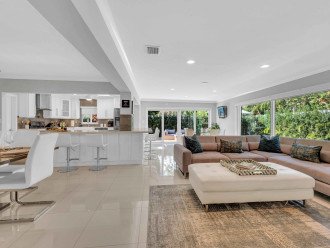 This modern coastal ranch style residence is ideal for tranquil relaxation and privacy with its lush garden and heated pool.