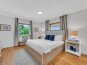 Sand Key - The primary bedroom features a king size bed and a smart TV