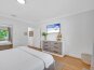 Sand Key - The primary bedroom features a king size bed and a smart TV