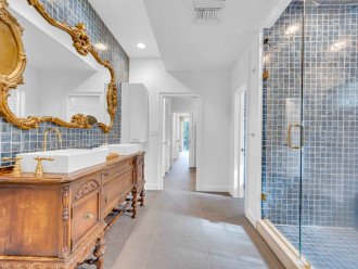 The GORGEOUS master bathroom, with a grand mirror, double vanity, and a walk-in shower