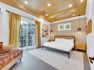 The Gold Room is the second bedroom, featuring a king-sized bed, access to a patio with south and east garden views, a 50" wall-mounted Smart TV, and an en suite bathroom.