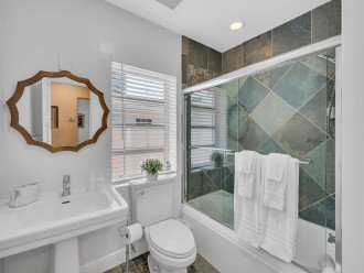 The master bathroom features a tub/shower combo with beautiful tile work.