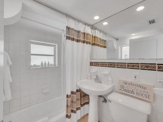 The guest bathroom also features a tub/shower combo