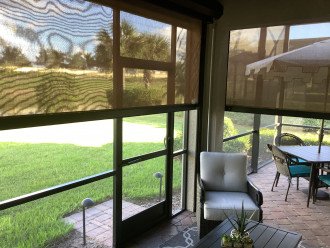 Remote controlled UV shades partially closed on covered lanai with ceiling fan