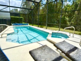 Beautiful pool area and outdoor spa overlooking woodlands