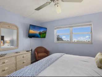 smart TV, full size dresser and corner chair