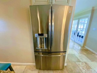 Oversized refrigerator has filtered water and ice dispenser in the door