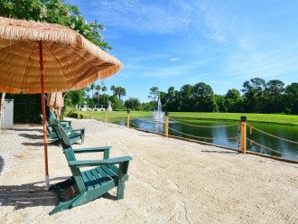 Relax on the beach area with a fountain lake view