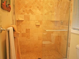 Tiled and glass enclosed shower in the "Fish Room".