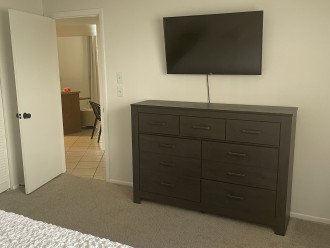 Second master bedroom with a king size bed and TV.