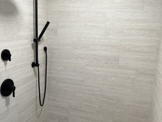Dual headed shower with one adjustable shower head.
