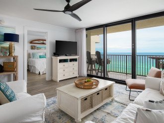 Living room with ceiling fan and balcony access.