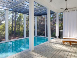 Pool with covered seating and a ceiling fan to keep you cool.