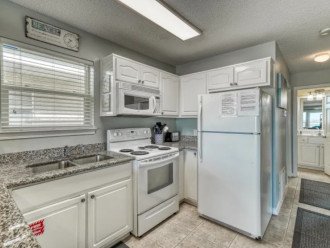 Kitchen has easy access to all appliances, sink and prep area