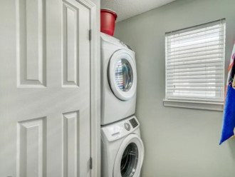 Large laundry room with beach towels and cleaning supplies