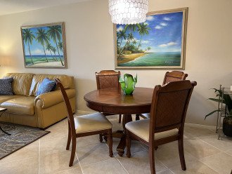 Tropical paintings decorate living and dining areas