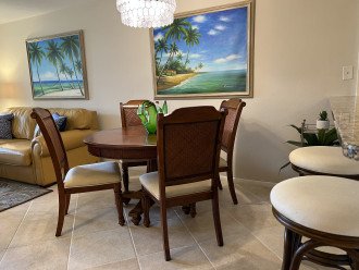 Dining table with 4 chairs plus two swivel bar stools at the counter