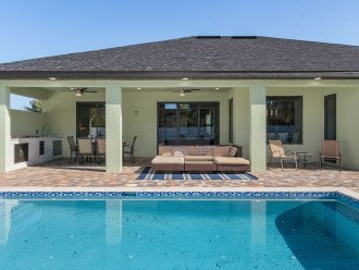 Covered patio, outdoor kitchen, gas grill, heated saltwater south facing pool.