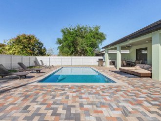 Patio has plenty of room to enjoy the sun in the heated, saltwater, south facing pool or to enjoy yard games (provided in garage).