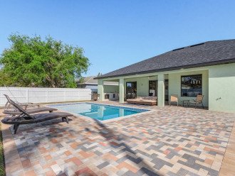 Patio has plenty of room to enjoy the sun in the heated saltwater pool or to enjoy yard games (provided in garage).