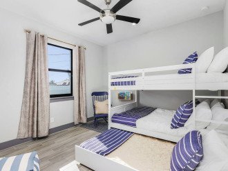 Bunk bed with a full-size mattress on the top and bottom as well as a twin size trundle bed that pulls out or tucks away as necessary. Room also has a walk-in closet with ample shelving and hanging space.