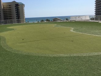 A putting green with the ocean view is just steps away from our condo