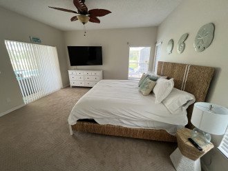 Master bedroom with new bed, furniture and 65" smart TV