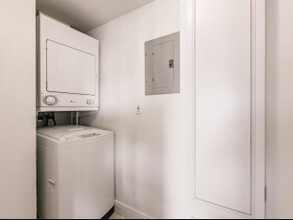 Separate laundry room with Washer dryer, pull down ironing board & linen closet
