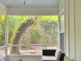 Screened lanai offers shade and views of private tropical gardens.