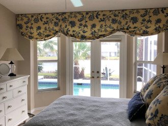 MASTER BEDROOM WITH FRENCH DOORS THAT OPEN TO POOL/LANAI