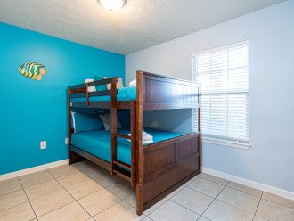 kids bedroom with bunk beds and flat tv screen