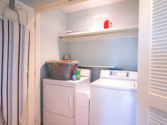 Laundry area is located in the hallway leading to the guest bedrooms