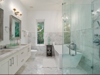 Ensuite Guest Bathroom Complete with Soaking Tub, Glass Door Walk In Shower and Dual Vanity Sinks