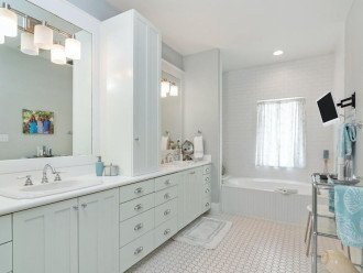 Master Bathroom with Dual Vanity Sinks, Tub, and Shower