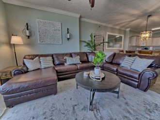 Living room has a comfortable sectional with a reclining chair on the end and a sleeper sofa