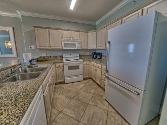 Kitchen has granite countertops, new refrigerator, and fully stocked with everything you will need to prepare meals