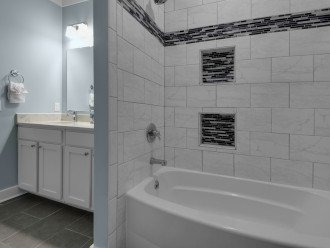 Modern tile, clean look, private toilet w/ door, extra large linen closet