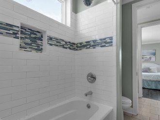 Modern Jack/Jill bathroom shower being shared by BR5 and BR6, bath rug