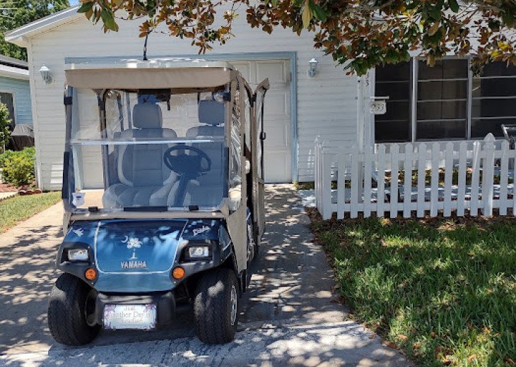 Front of villa with golf cart-gas golf cart has enclosure