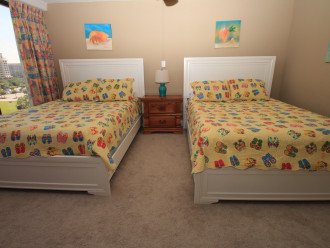 Two queen beds in spacious third bedroom.