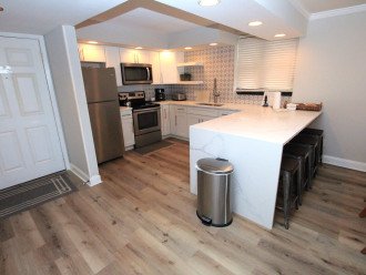 View of the remodeled kitchen and barstools