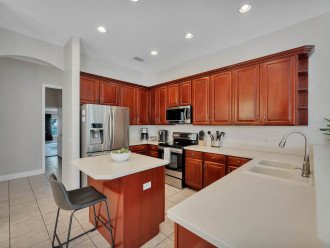 generous kitchen boasts maple cabinets with a cherry finish