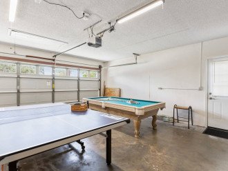 Pool table and ping pong table in the game room in the garage with Air Conditioned AC unit installed to keep the place cool and enjoyable in all weather conditions.